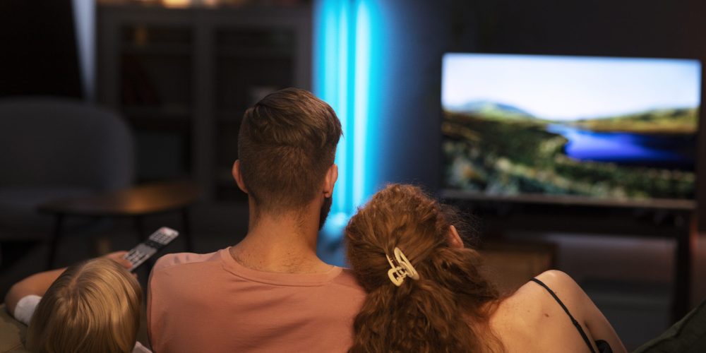 back-view-family-watching-tv