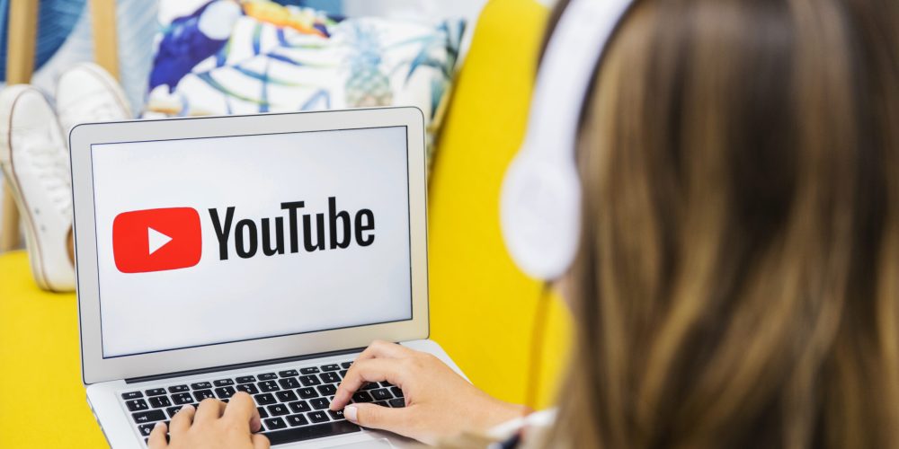 female-with-headphones-watching-laptop